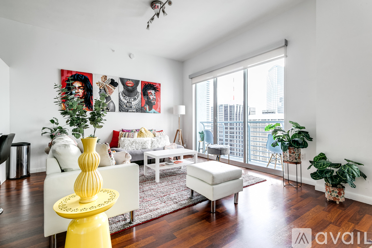 A living room with a yellow table and a white couch.