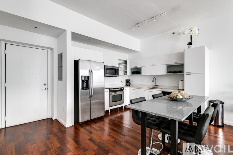 A modern kitchen with a dining table and chairs.