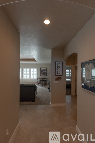 A living room with a couch and a painting on the wall.