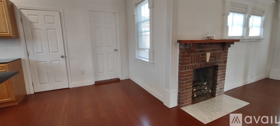 A living room with a fireplace and two doors.