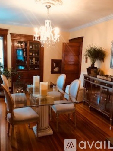 A dining room with a glass table and chairs.