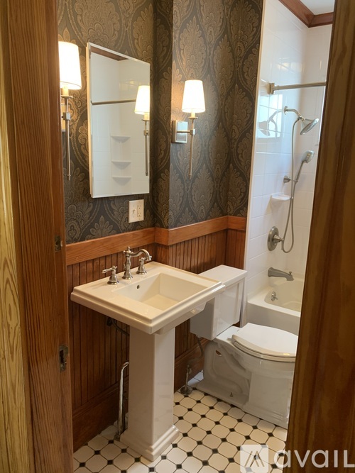 A bathroom with a sink, toilet and shower.