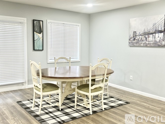 A dining room with a wooden table and chairs.