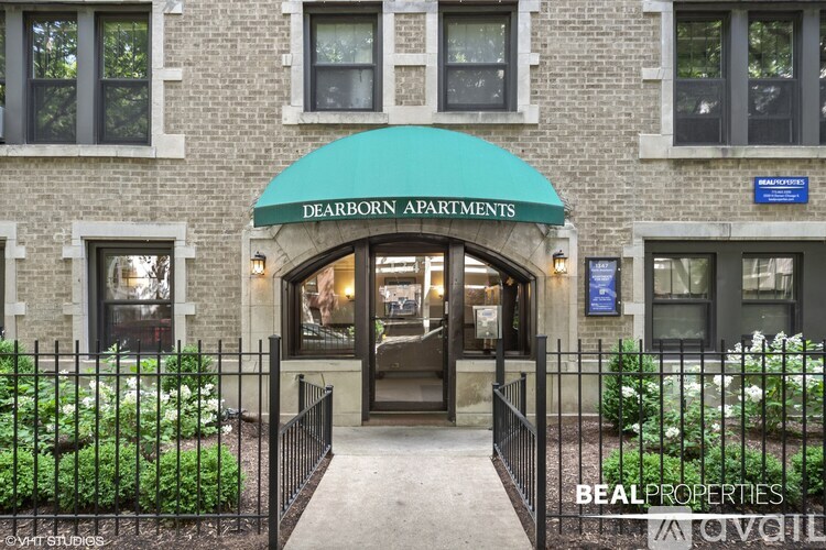 The entrance to the Dearborn Apartments is framed by a black metal fence.