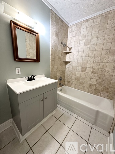 A bathroom with a white sink and a bathtub.