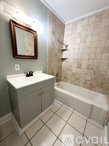 A bathroom with a white sink and a bathtub.