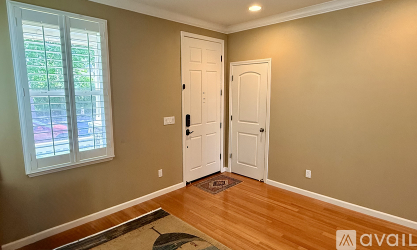 A room with two doors and a window.