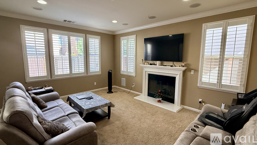 A living room with a fireplace and a television.