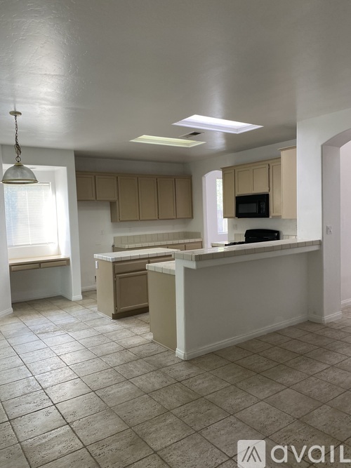 A kitchen with a white counter and cabinets.