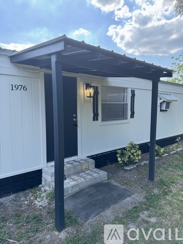 A small white building with the number 1976 on it.
