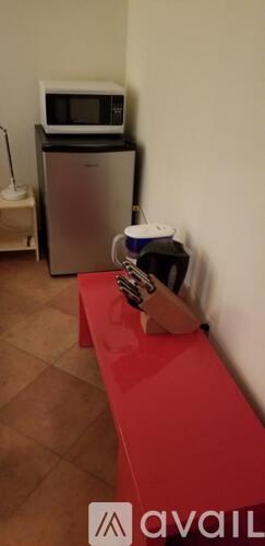 A red bench with a box on it.