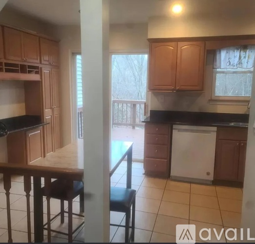 A kitchen with wooden cabinets and a black countertop.