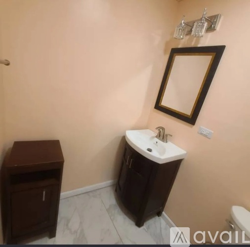 A bathroom with a sink, toilet, and medicine cabinet.
