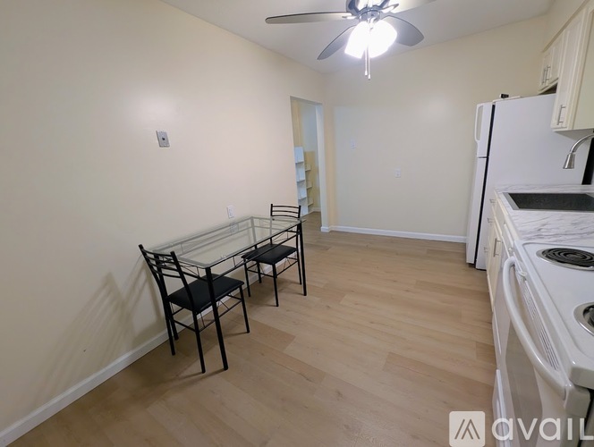A kitchen with a table and chairs in the middle of the room.