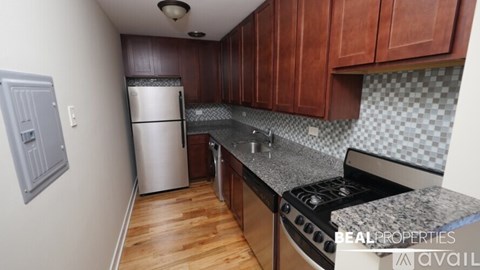 A kitchen with wooden cabinets and a stove top oven.