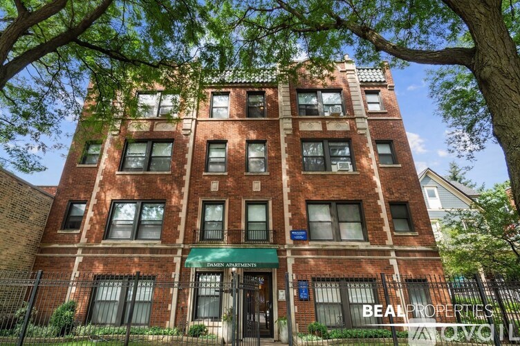 A red brick building with a green awning and a sign that says "BEAR PROPERTIES".