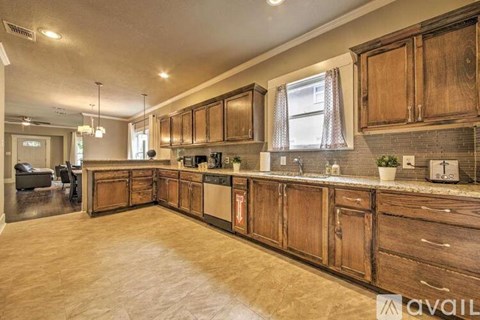 A kitchen with wooden cabinets and a countertop.