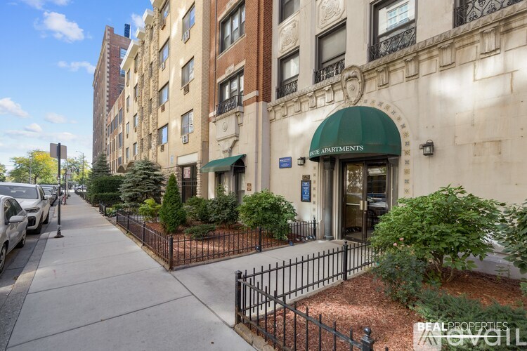 A street view of a building with the sign "Apartments" on the front.