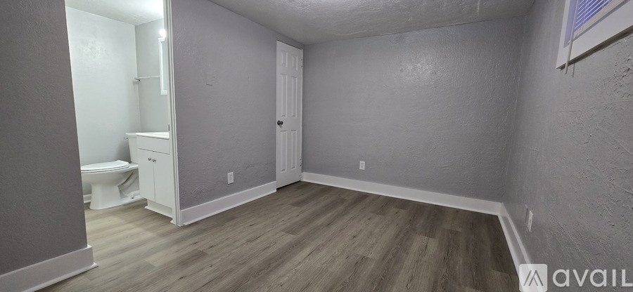 A small, empty room with a toilet and a sink.