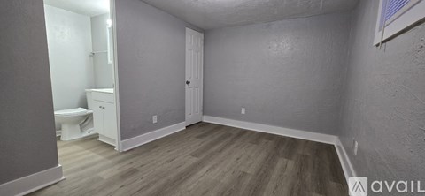 A small, empty room with a toilet and a sink.