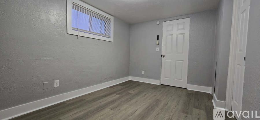 A room with a door and a window.