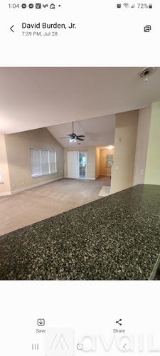 A room with a ceiling fan and a large countertop.