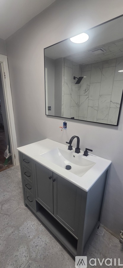 A bathroom with a sink and a mirror.
