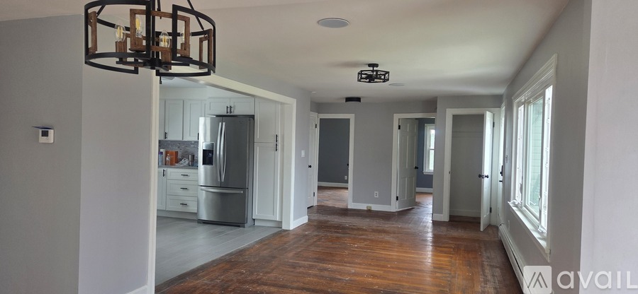 A large open room with a kitchen in the background.