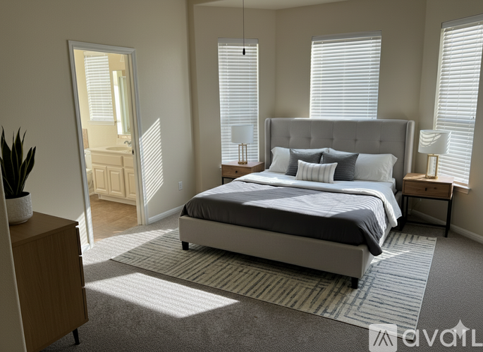 A bedroom with a large bed and a wooden dresser.