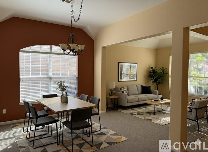 A dining room with a table set for six and a couch in the background.