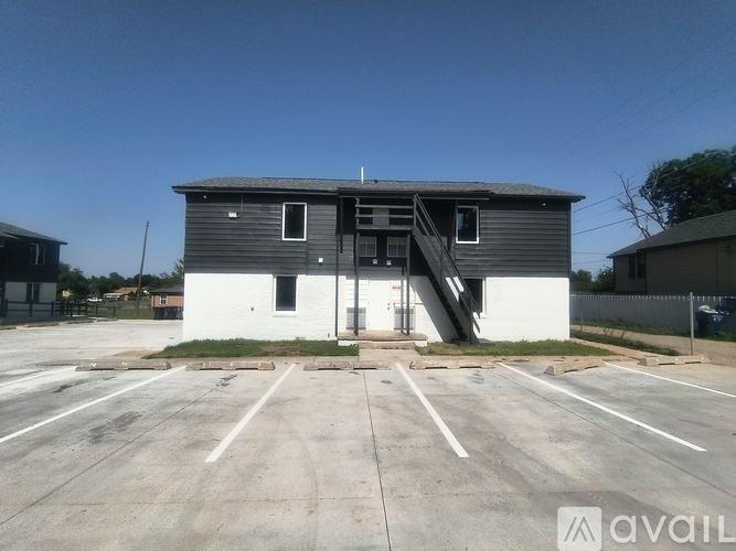 A building with a parking lot in front of it.