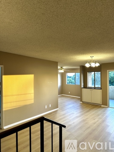 A room with a balcony and a painting on the wall.