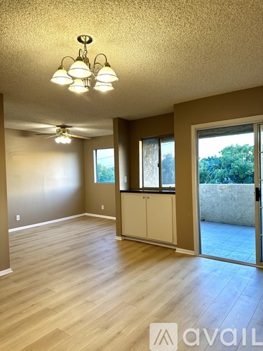 A room with wooden floors and a ceiling fan.