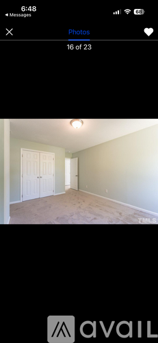 A room with a white door and a light on the ceiling.