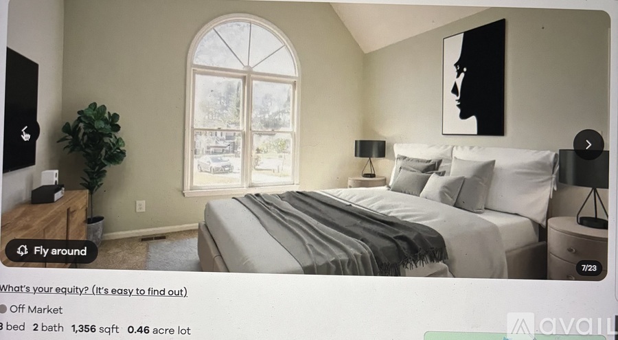 A bedroom with a large bed and a window.