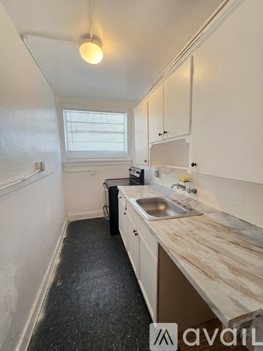 A kitchen with a sink and a window.