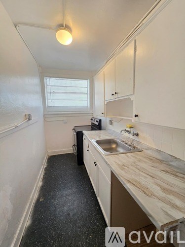 A kitchen with a sink and a window.
