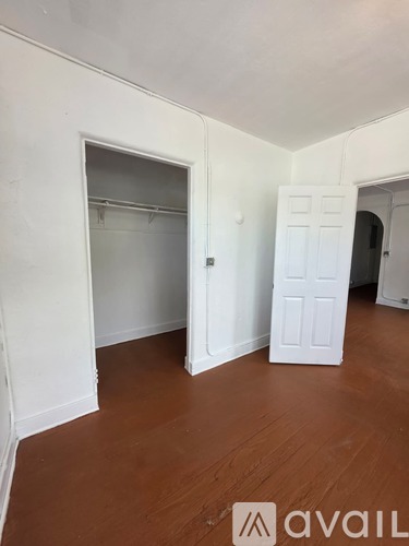 A room with white walls and a wooden floor.
