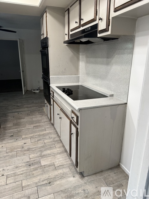 A kitchen with a sink and cabinets.