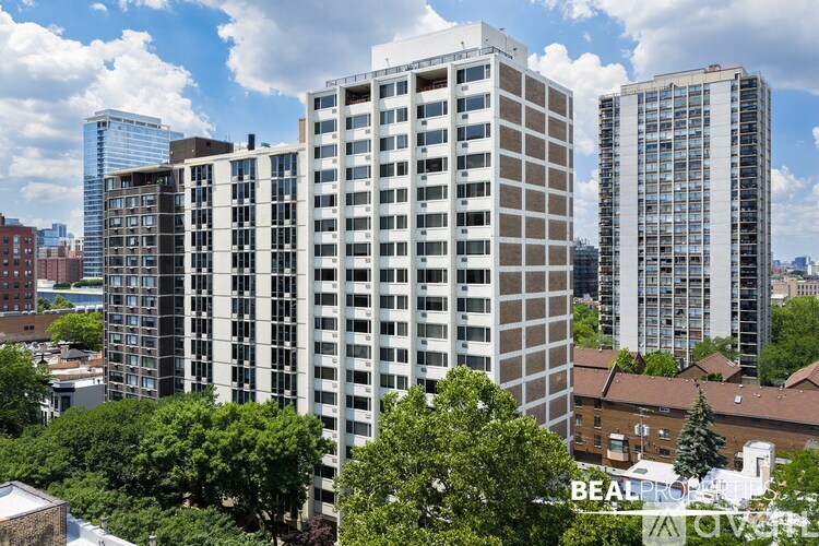 A group of high-rise buildings are surrounded by trees.