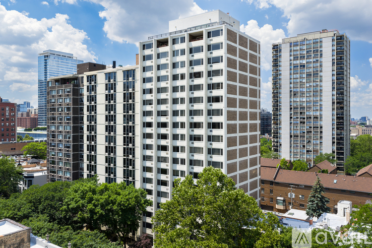 A group of buildings with trees in front of them.