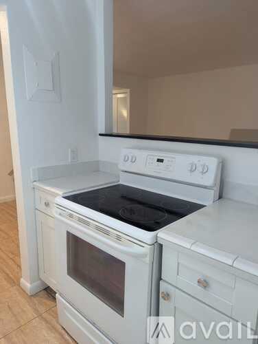 A white oven with a black top is in a kitchen.