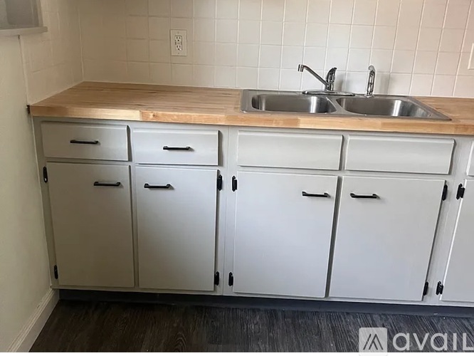 A kitchen with a sink and cabinets.