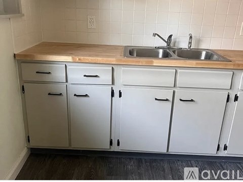 A kitchen with a sink and cabinets.