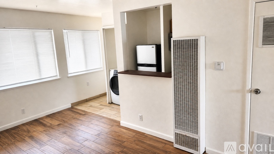 A room with a television and a washing machine.