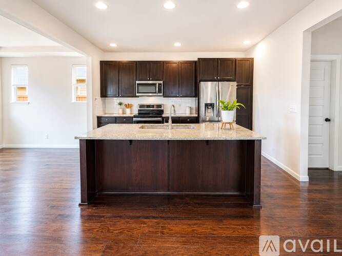 A kitchen with dark wood cabinets and a central island.