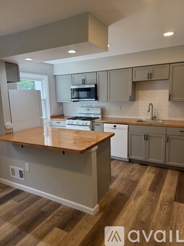 A kitchen with wooden floors and a countertop.