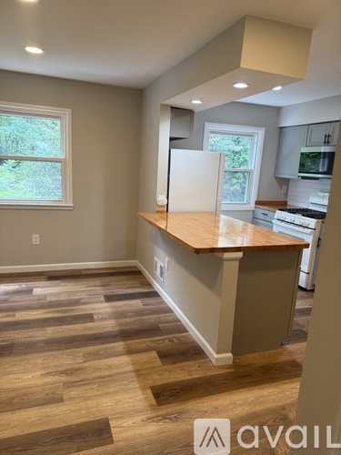 A kitchen with a wooden floor and a counter.