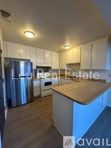 A kitchen with a wooden countertop and stainless steel appliances.