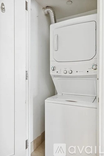 A white oven with a door open is in a kitchen.